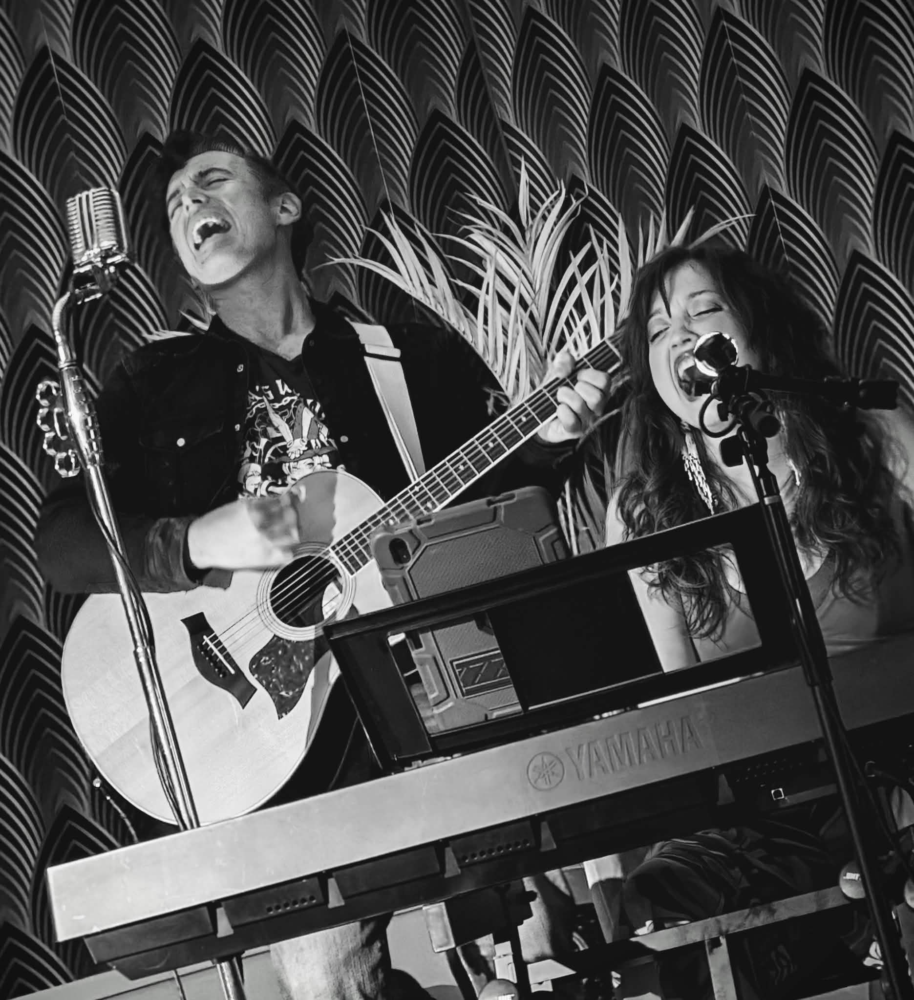 Courtney Thompson performing at the piano with a guitarist