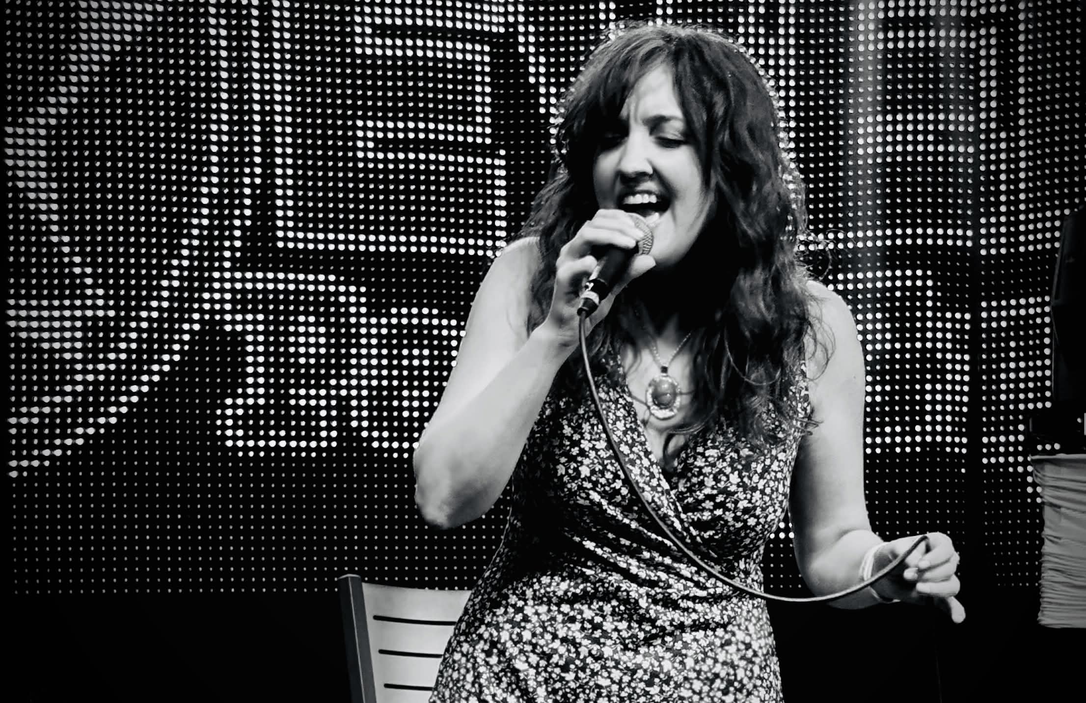 Courtney Thompson singing live on stage